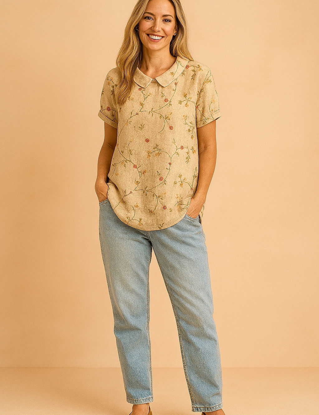 Blouse met korte mouwen en een beige achtergrond, versierd met subtiele geborduurde takjes en kleine roze bloemetjes in een vintage bloemenpatroon.