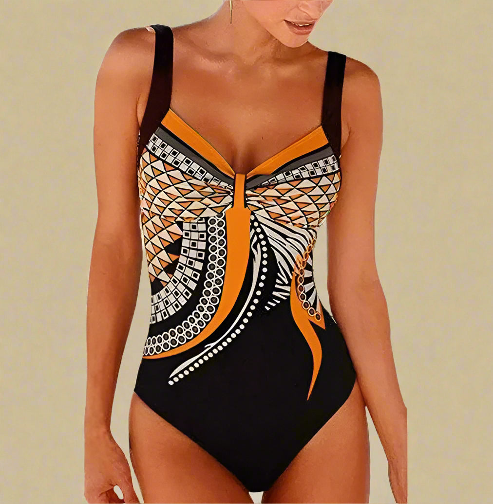 Zwart badpak met oranje en beige geometrische accenten en centrale twist