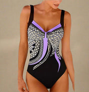 Zwart badpak met lila paarse geometrische print en twist voor een flatterende pasvorm