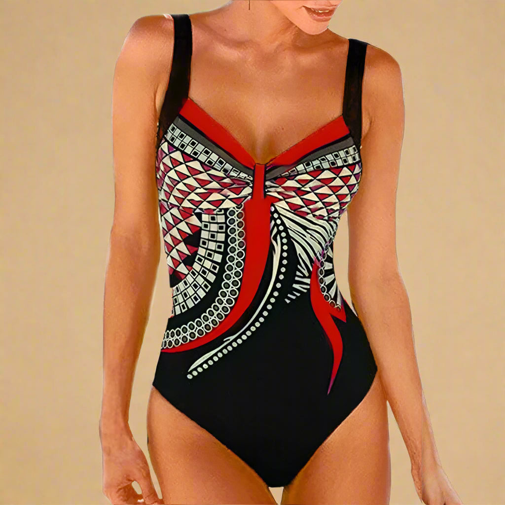  Zwart badpak met rood geometrisch patroon en twistdetail aan de voorkant