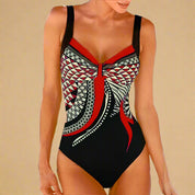  Zwart badpak met rood geometrisch patroon en twistdetail aan de voorkant