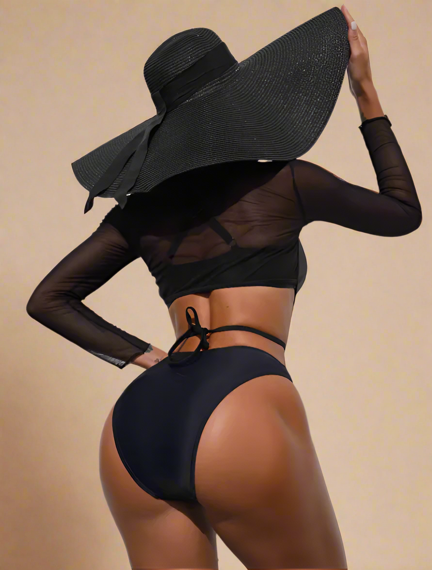 Zwart cut-out badpak met lange mesh mouwen en gekruiste bandjes in opvallend asymmetrisch ontwerp