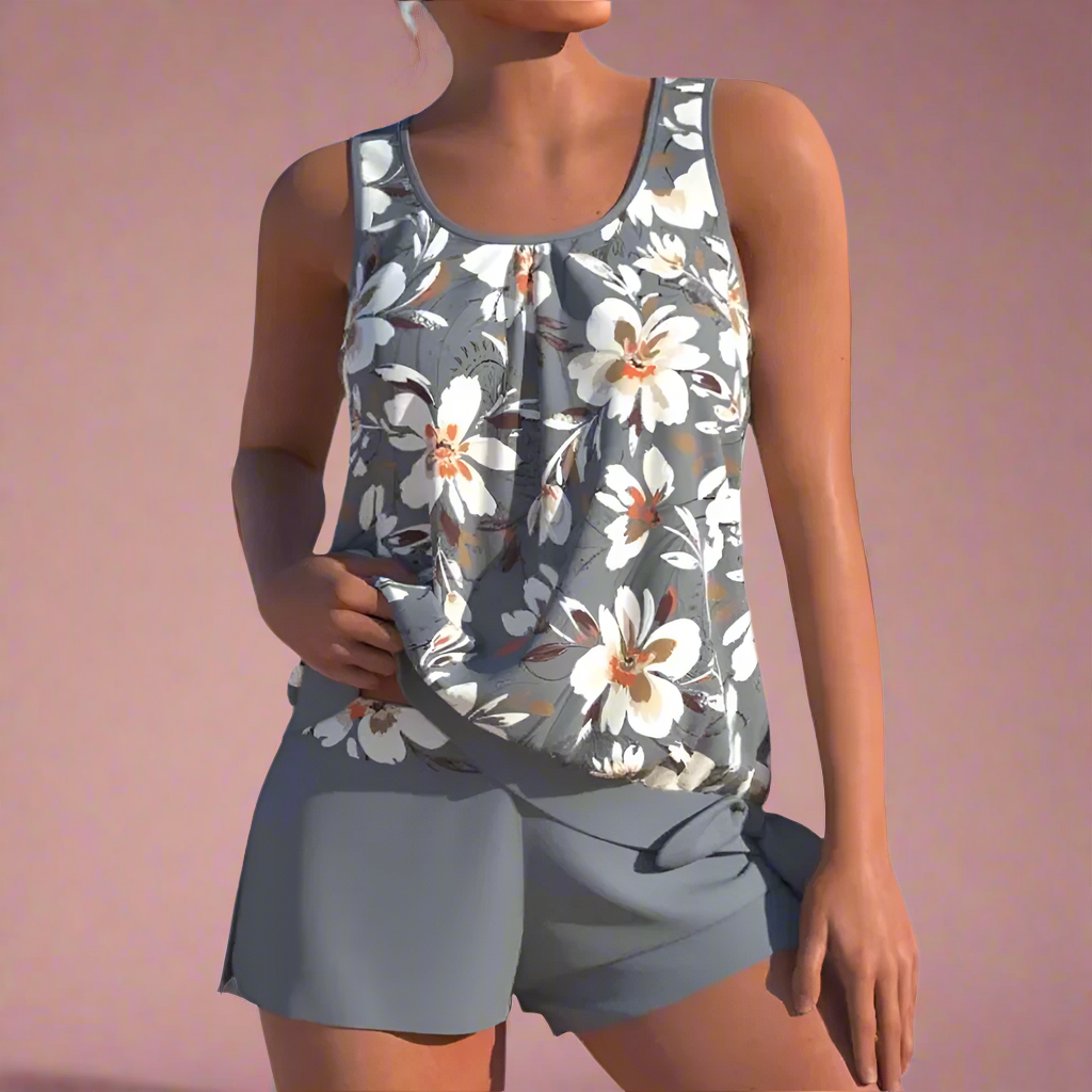 Donkergrijze dames pyjamaset met grote witte bloemenprint en mouwloos hemdje met bijpassende shorts.