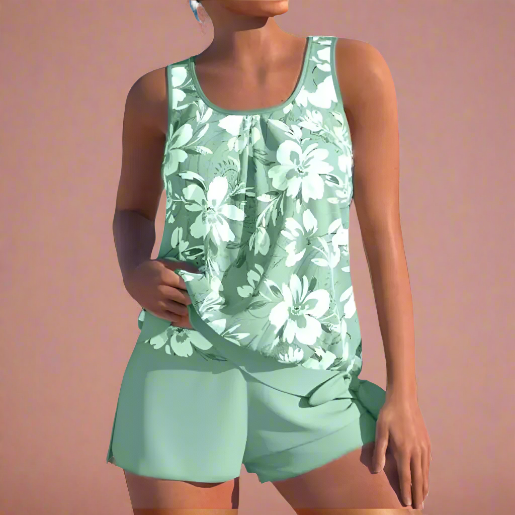 Mintgroen dames pyjamaset met mouwloos bloemenhemd en losse korte broek, ideaal voor zomerse nachten.