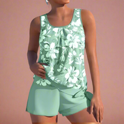 Mintgroen dames pyjamaset met mouwloos bloemenhemd en losse korte broek, ideaal voor zomerse nachten.
