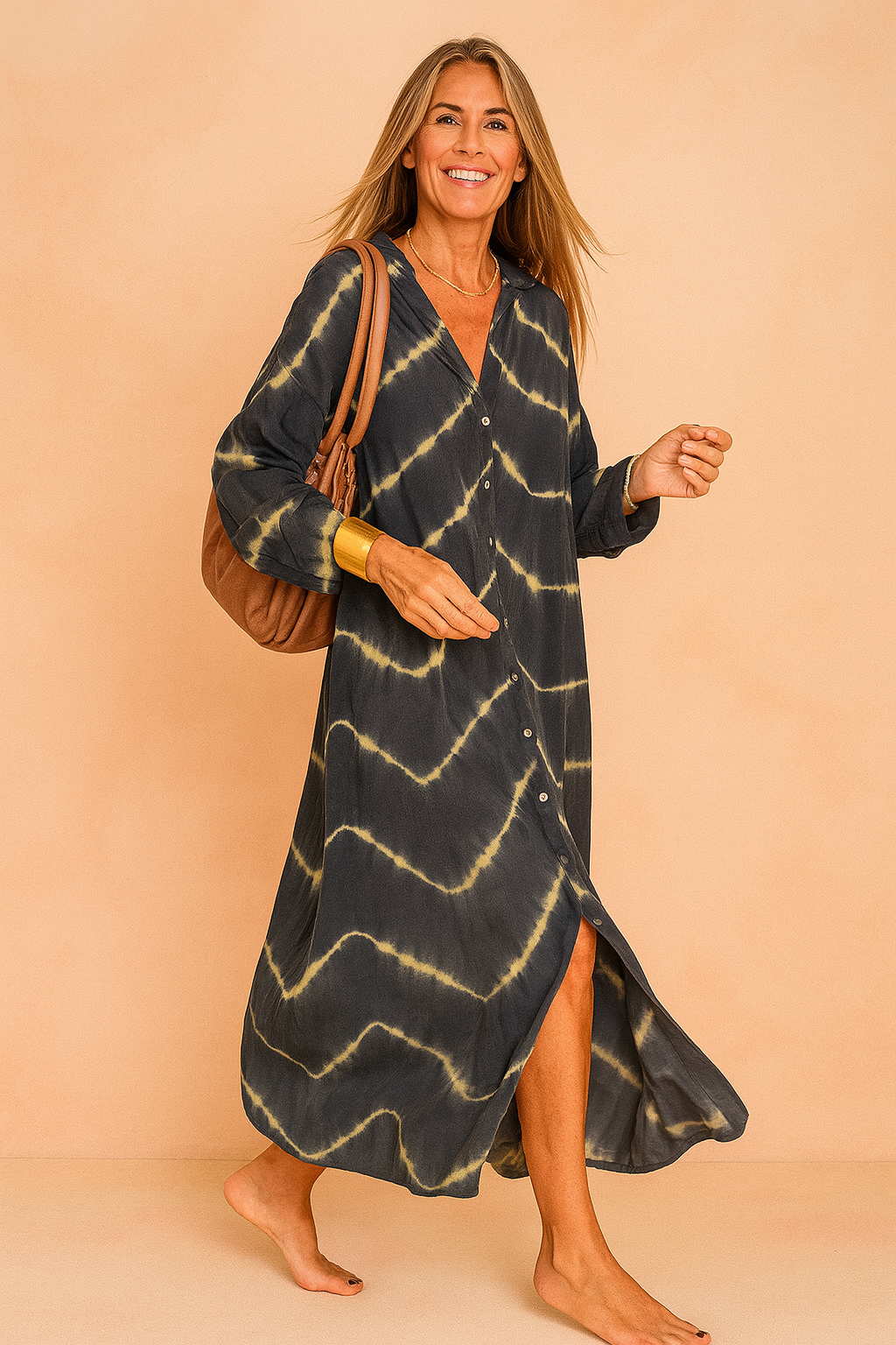 Oversized maxi jurk met tie-dye patroon in donkerblauw en beige, V-hals en knoopsluiting aan de voorkant.