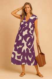 Mouwloze A-lijn zomerjurk met paarse en beige abstracte print en V-hals