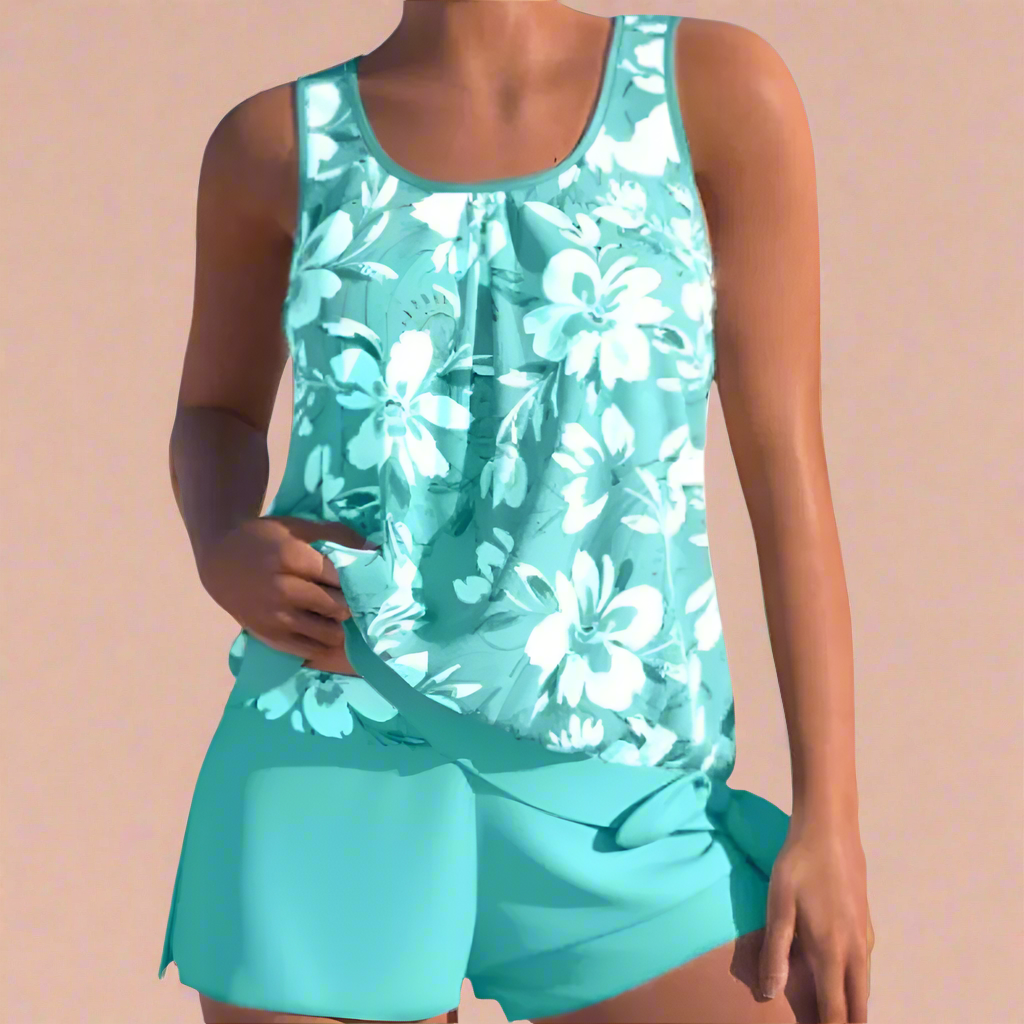 Turquoise dames pyjamaset met tropisch bloemenpatroon en comfortabele pasvorm, perfect voor warm weer.